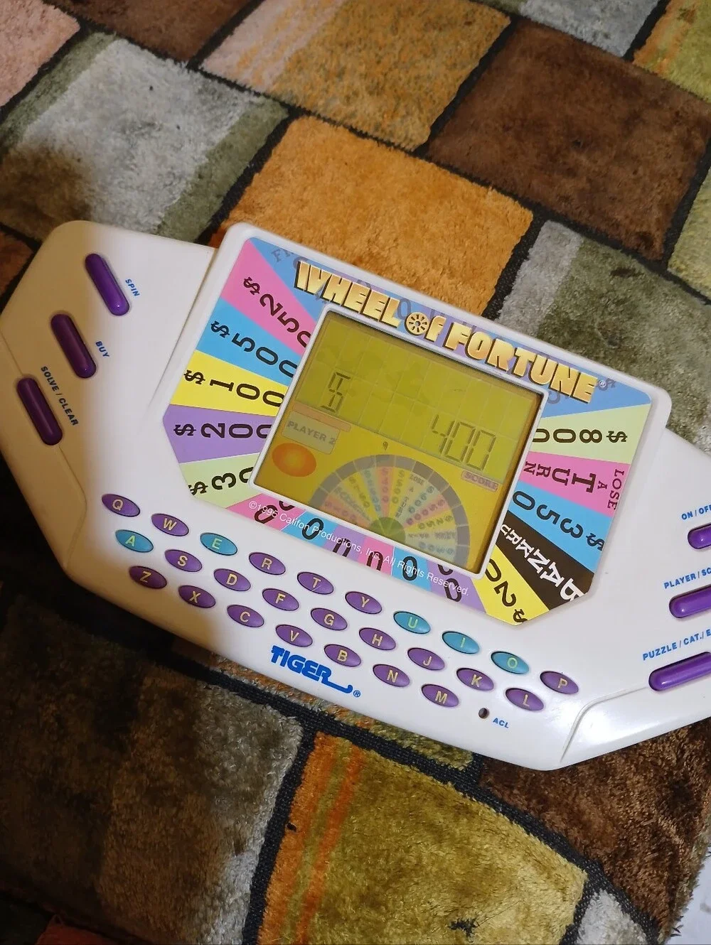 Tiger Electronics Wheel of Fortune Handheld Game - White with Purple Keys